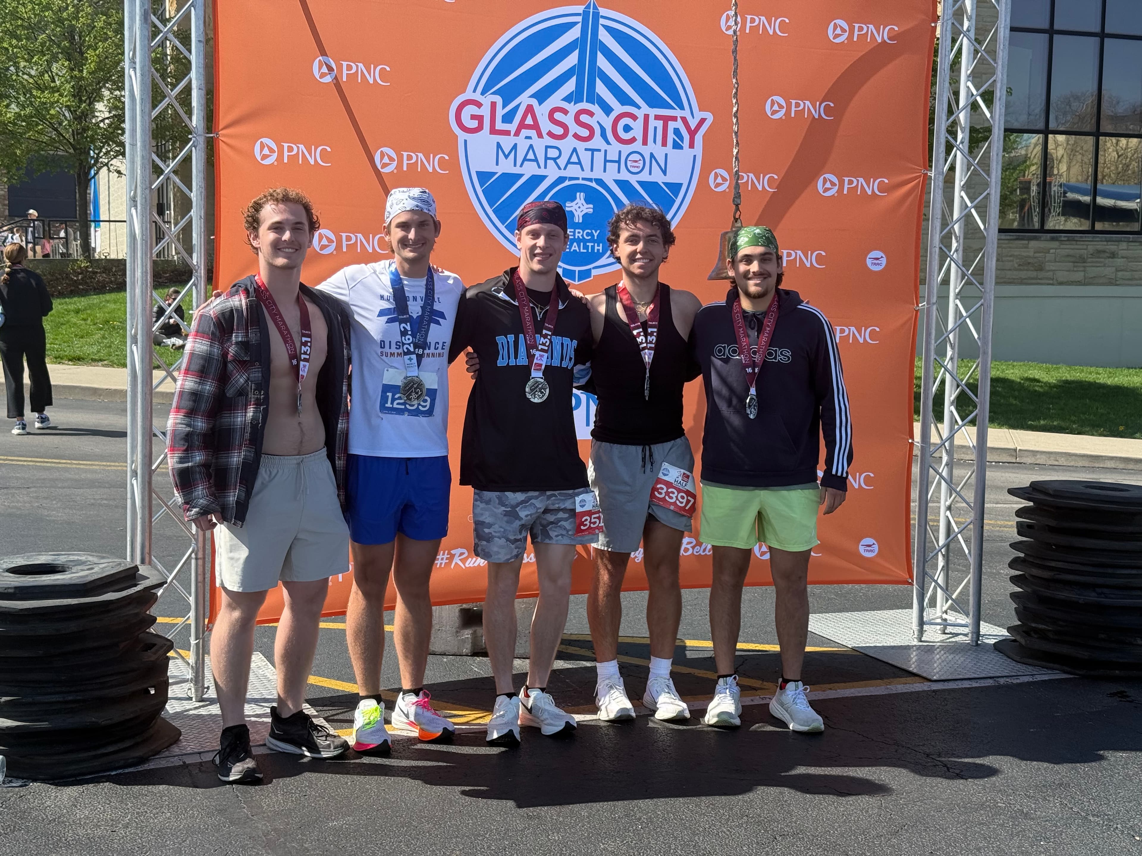 A long distance marathon runner, jogging along a wooded trail.